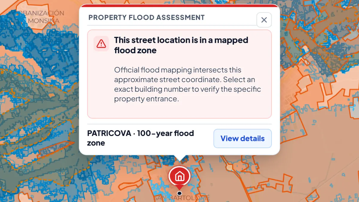 BarrioRadar flood check for a street in Orihuela, Alicante, showing the property marker inside shaded official flood zones and the result This street location is in a mapped flood zone